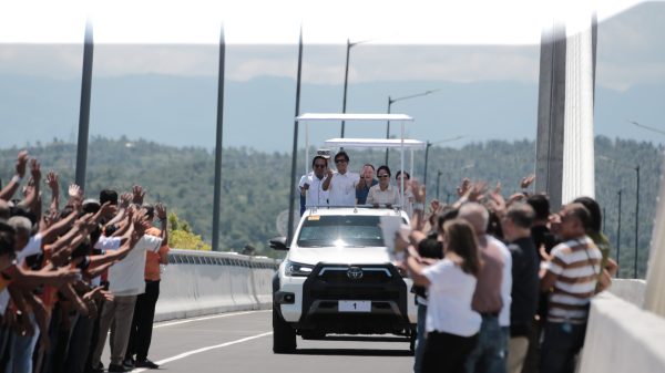 President Ferdinand Marcos Jr. and First Lady Louise Araneta-Marcos, along with Department of Public Works and Highways Secretary Manuel M. Bonoan, drive through the newly inaugurated Panguil Bay Bridge, warmly welcomed by various sectors set to benefit from this vital infrastructure. (Photo: JAKA/PIA-10/Lanao del Norte)