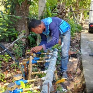 Personnel of Camiguin Water Company facilitated the change of the meter and reconnection at Cenote, Bug-ong, Mambajao, Camiguin. (Photo courtesy of CWC)