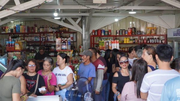 Beneficiaries use their AKAP Rice identification cards to purchase rice at a 50 percent discount from accredited retailers across the province. (Photo courtesy of LGU Camiguin)